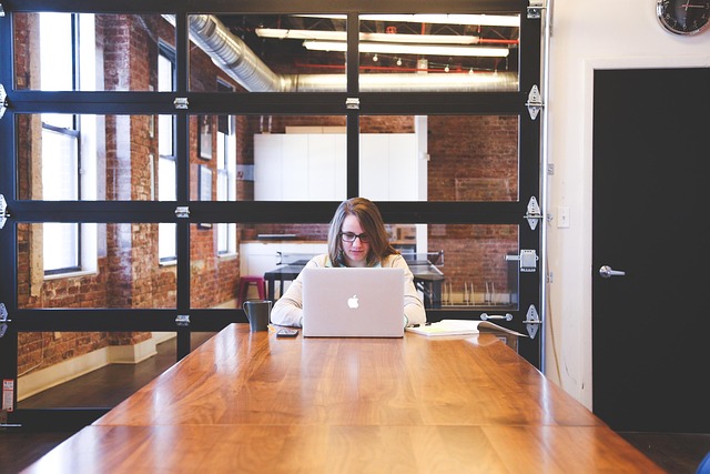 professional reviewing terms and policies on laptop in modern office setting
